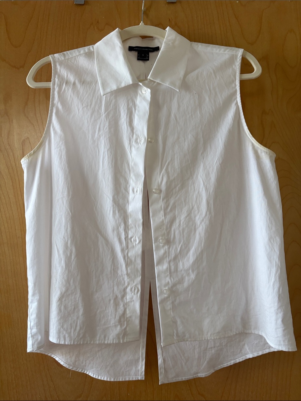 Sleeveless White Button-Down Shirt with bow detail